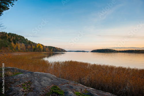  Wonderful sunset on the lake. View of Lake Ladoga in the autumn evening. Russia, Karelia.