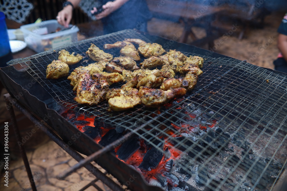 BBQ Honey Chicken, Malaysian food is on the grill with smoke.