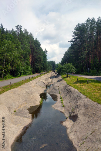 Empty artificial canal for sports in the forest.