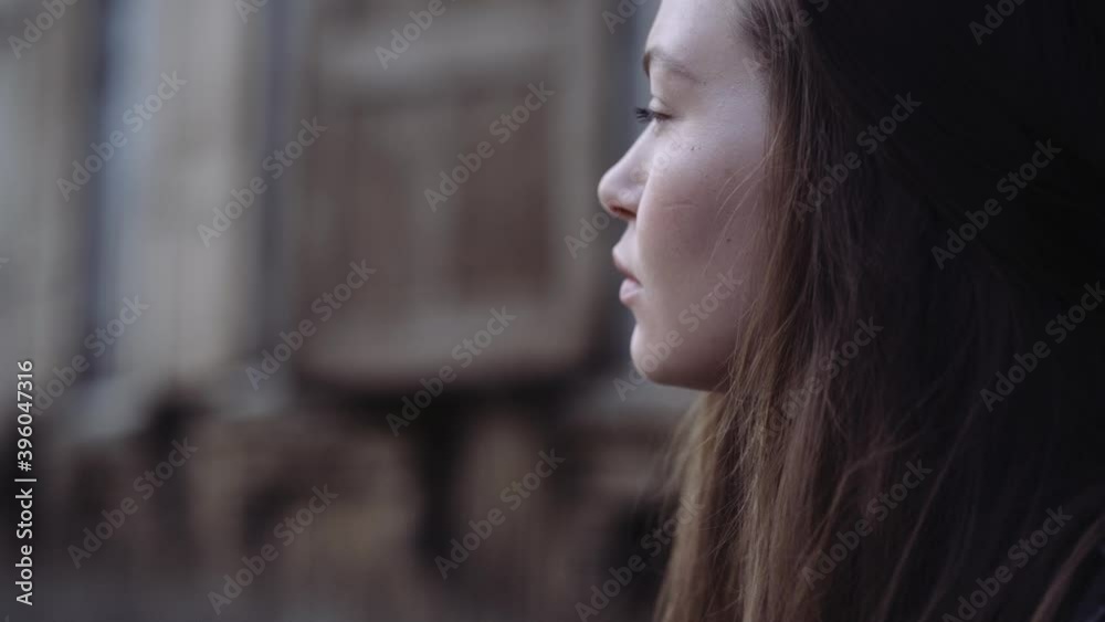 portrait of a girl on the background of the old city, concept of urban environment, loneliness or waiting portrait of a girl on the background of the old city, concept of urban environment, loneliness or waiting