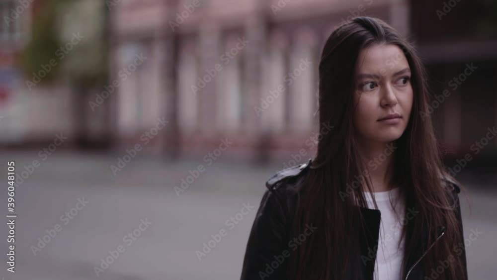 girl walking in the city on the background of the old city, urban environment concept, loneliness or waiting for urbanism and street style girl walking in the city on the background of the old city, urban environment concept, loneliness or waiting for urbanism and street style