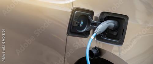 Close-up of an electric car with connected cable