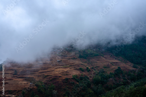 misty fog over village in mountains