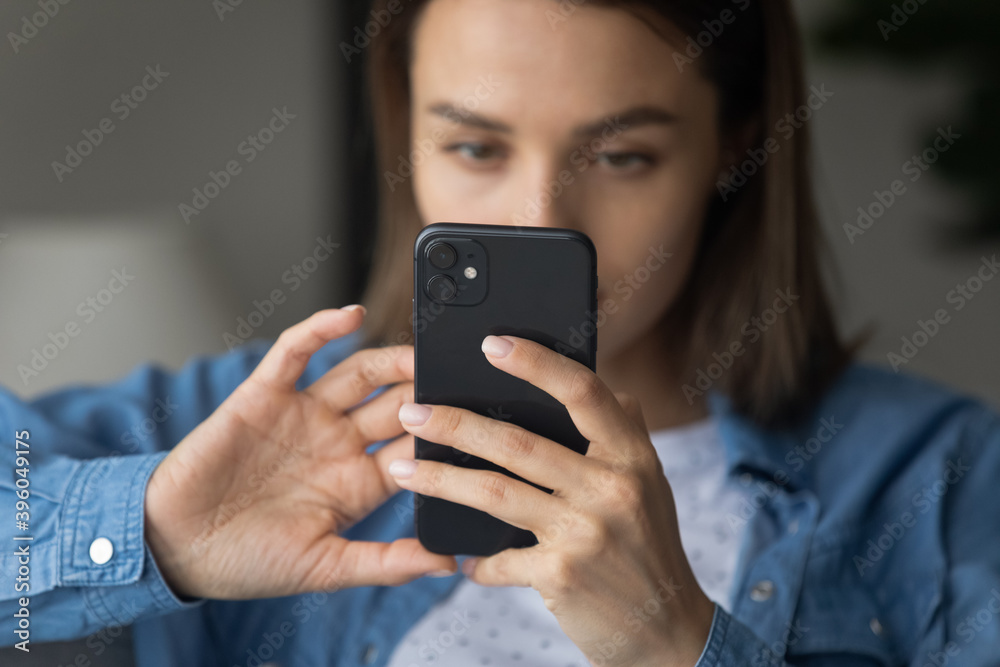 Close up of young Caucasian woman hold smartphone make picture with good quality camera on gadget. Millennial female client customer look at cellphone screen browse wireless internet on device. Close up of young Caucasian woman hold smartphone make picture with good quality camera on gadget. Millennial female client customer look at cellphone screen browse wireless internet on device.