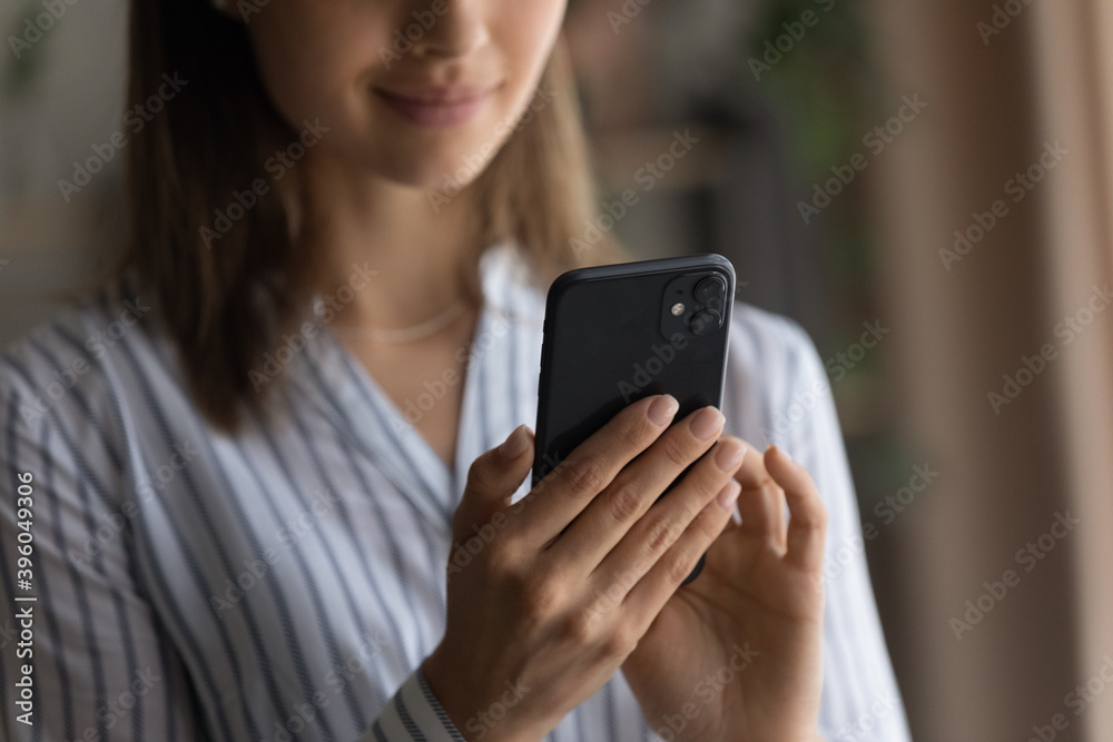 Crop close up of woman hold modern smartphone browsing surfing wireless internet on gadget. Happy female client or customer use cellphone device, text or message or shop online. Technology concept. Crop close up of woman hold modern smartphone browsing surfing wireless internet on gadget. Happy female client or customer use cellphone device, text or message or shop online. Technology concept.