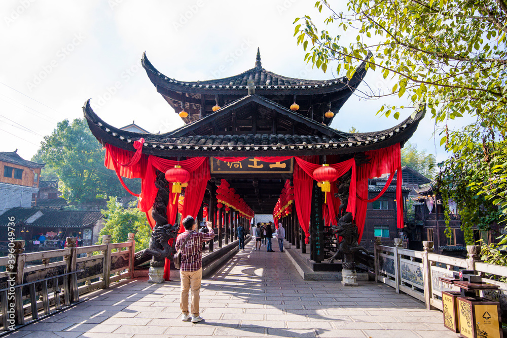 Fototapeta premium Street view local visitor and tourist in Furong Ancient Town (Furong Zhen, Hibiscus Town), China. Furong Ancient Town is famous tourism attraction place.