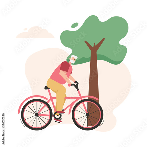 Grandfather riding bike at park. Elderly man cycling