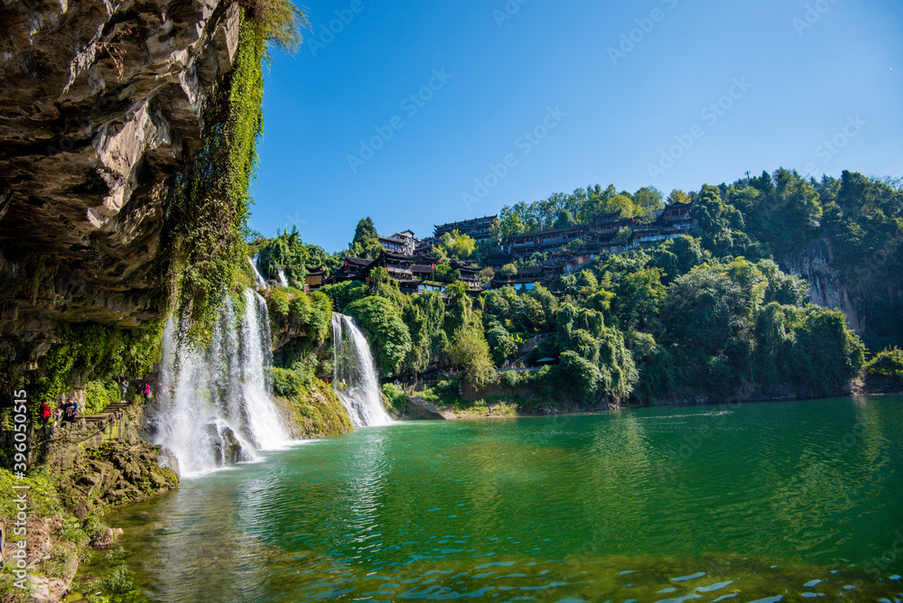 Obraz premium The Wangcun Waterfall at Furong Ancient Town. Amazing beautiful landscape scene of Furong Ancient Town (Furong Zhen, Hibiscus Town), China