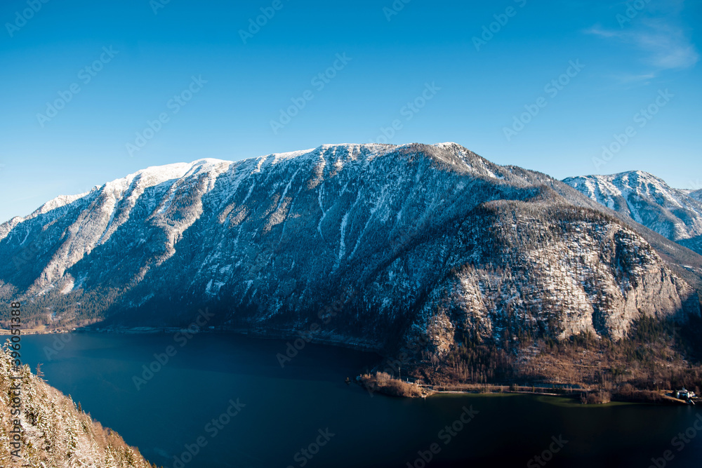 Amazing view of snowy mountains by lake over blue sky