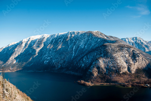 Amazing view of snowy mountains by lake over blue sky