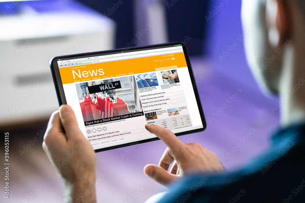 Fototapeta premium Man Using Tablet Computer Reading Electronic News