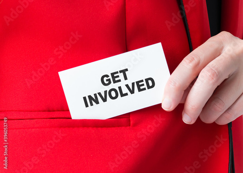 Businessman puts a card with text GET INVOLVED in his pocket, business concept