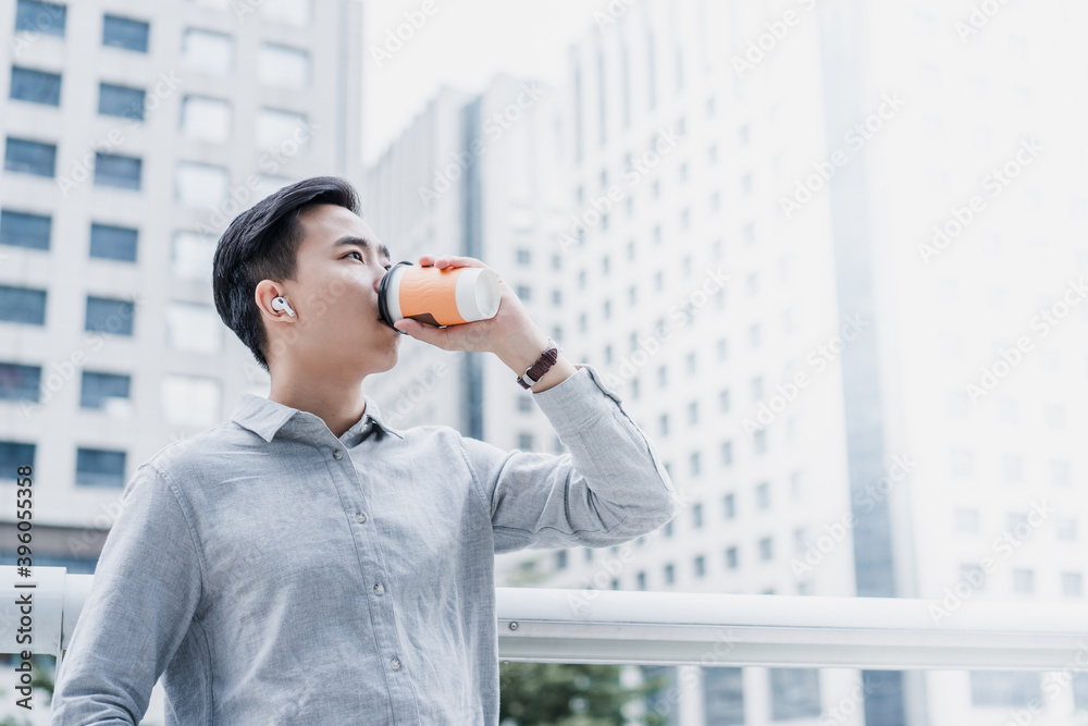 Business people is drinking packaged coffee outdoors Business people is drinking packaged coffee outdoors