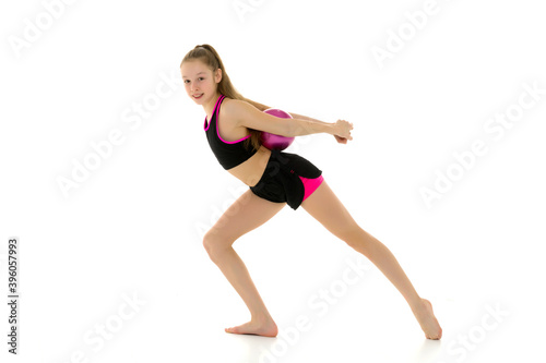Fototapeta Naklejka Na Ścianę i Meble -  Girl gymnast performs exercises with the ball.