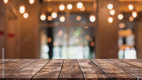 Empty wood table top and blurred coffee shop  cafe and restaurant interior background - can used for display or montage your products.