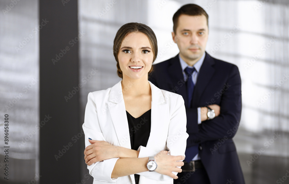 Self-confident business people are standing together with crossed arms in an office at meeting. Concept of success in a business Self-confident business people are standing together with crossed arms in an office at meeting. Concept of success in a business