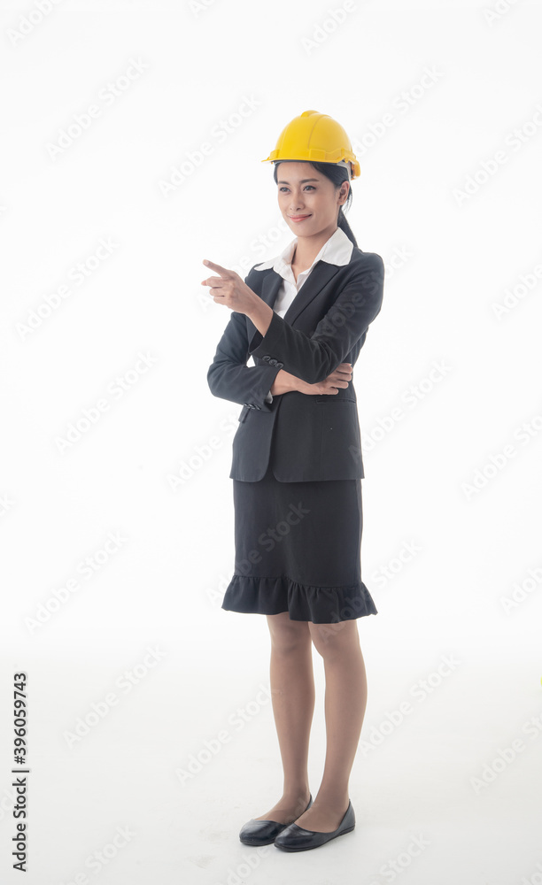 Young engineer woman wear black suit and yellow safety helmet with arm cross on isolated white background. Young engineer woman wear black suit and yellow safety helmet with arm cross on isolated white background.