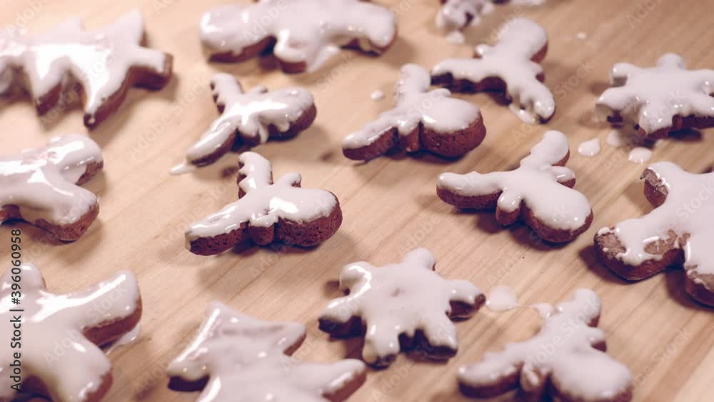 Person decorating gingerbread cookies for Christmas. Person decorating gingerbread cookies for Christmas.