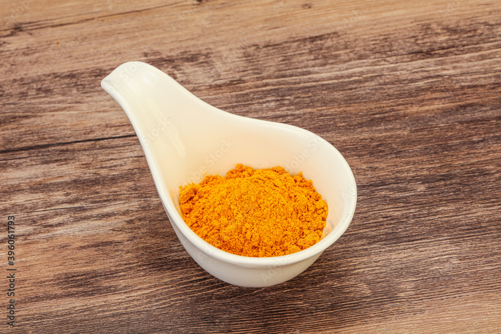 Tumeric powder in the bowl Tumeric powder in the bowl