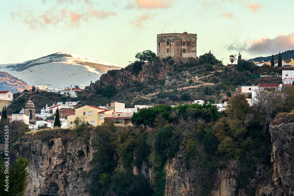 Arab castle of the Ulloa in the town of Velez de Benaudalla with Sierra Nevada in the background.
