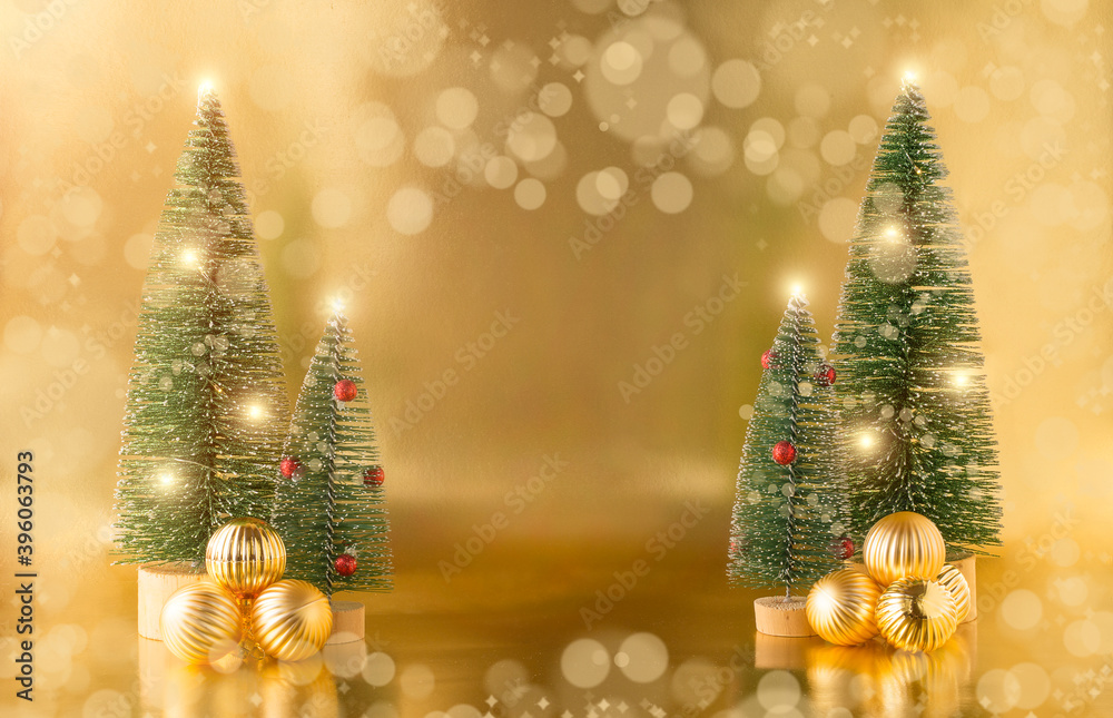 Golden Christmas balls on the background of Christmas trees on a Golden background. Christmas card. space for text