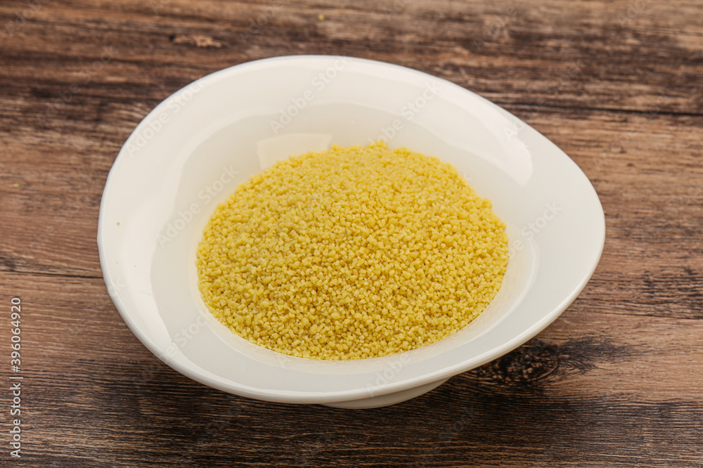 Raw cous cous heap in the bowl Raw cous cous heap in the bowl
