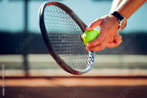 Tennis player's hand preparing to take a serve © fotofabrika