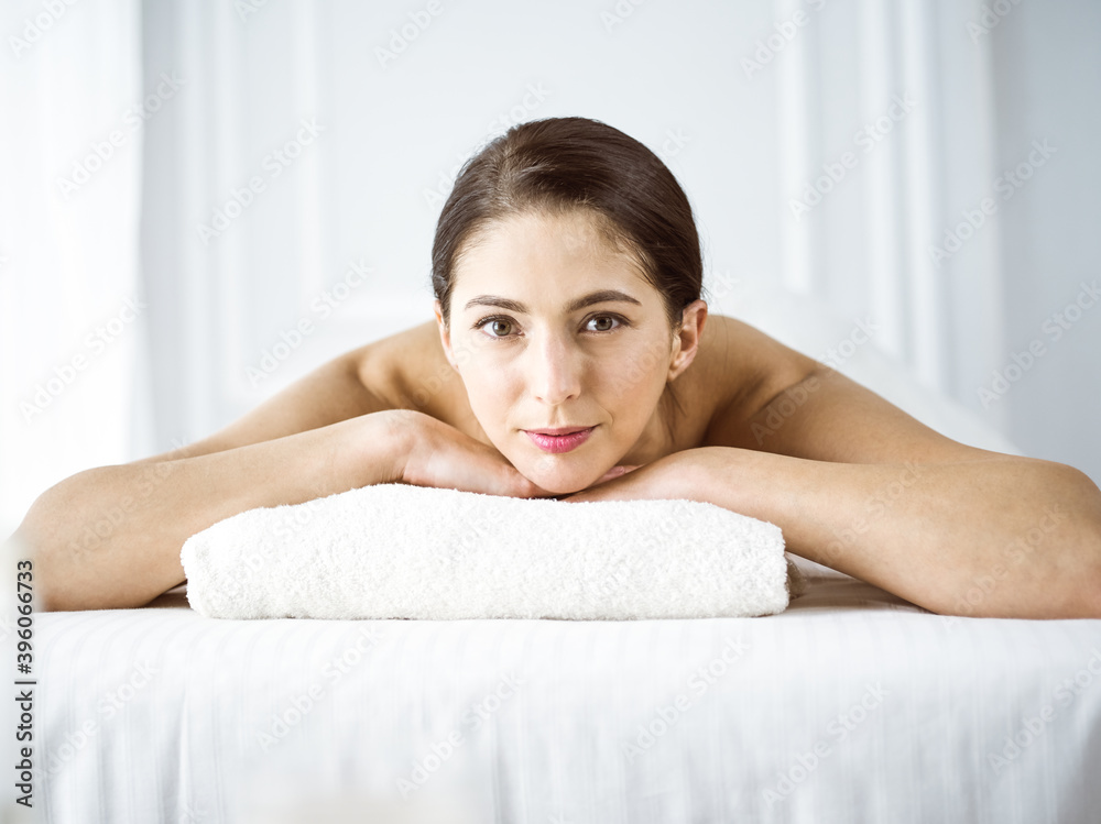 Portrait of smiling brunette woman looking at camera. Beauty concept Portrait of smiling brunette woman looking at camera. Beauty concept