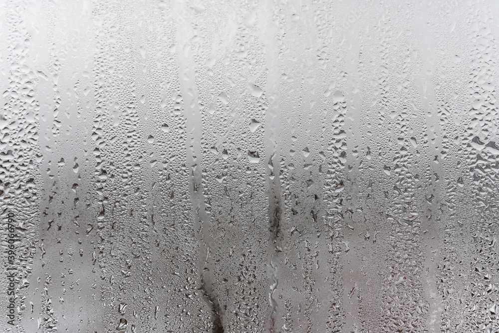 Fototapeta premium Dripping Condensation, Water Drops Background Rain drop Condensation Texture. Close up for misted glass with droplets of water draining down