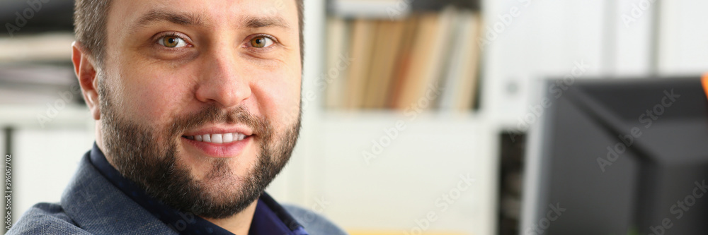 Fototapeta premium Delighted brunette businessman expressing positivity while looking at camera, going to work at his project