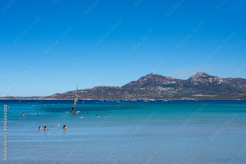 Obraz premium Calvi beach in summer view of the turquoise blue sea with the mountains in the background