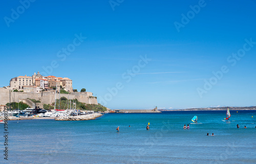 Calvi beach in summer view of the turquoise blue sea with people © JeanBrummel