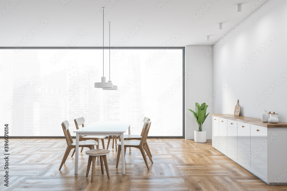 White and wooden dining room with window, light furniture on parquet floor White and wooden dining room with window, light furniture on parquet floor