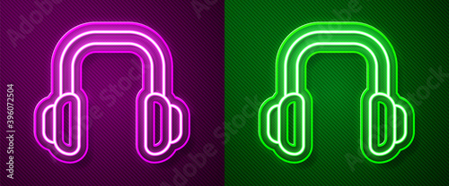 Glowing neon line Winter headphones icon isolated on purple and green background. Earmuffs sign. Vector.