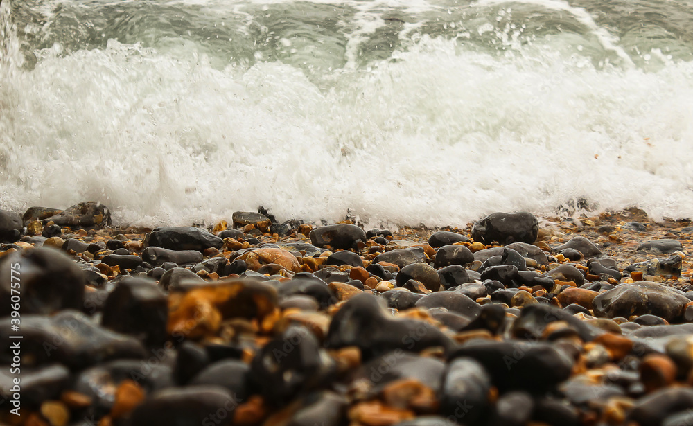 Obraz premium Pebbles and waves balance, Background.