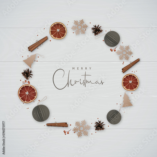 Christmas composition with snowflakes, cinnamon, orange slices, pine cones and decorative paper balls isolated on wooden background. Beautiful Christmas wreath in minimalist style.