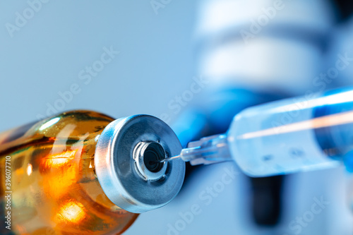 Vaccine bottle with a syringe taking the vaccine from it