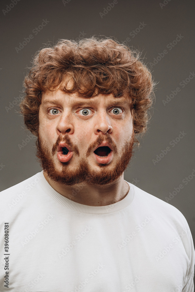 Shocked, amazed. Young man with dual emotions combination on face isolated on dark background, emotional and expressive. Concept of phycology, mental health, person unique, facial expression, sales Shocked, amazed. Young man with dual emotions combination on face isolated on dark background, emotional and expressive. Concept of phycology, mental health, person unique, facial expression, sales