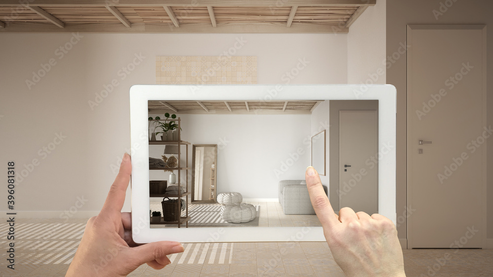 Augmented reality concept. Hand holding tablet with AR application used to simulate furniture and design products in empty interior with ceramic tiles. Bathroom with sofa and shelves Augmented reality concept. Hand holding tablet with AR application used to simulate furniture and design products in empty interior with ceramic tiles. Bathroom with sofa and shelves