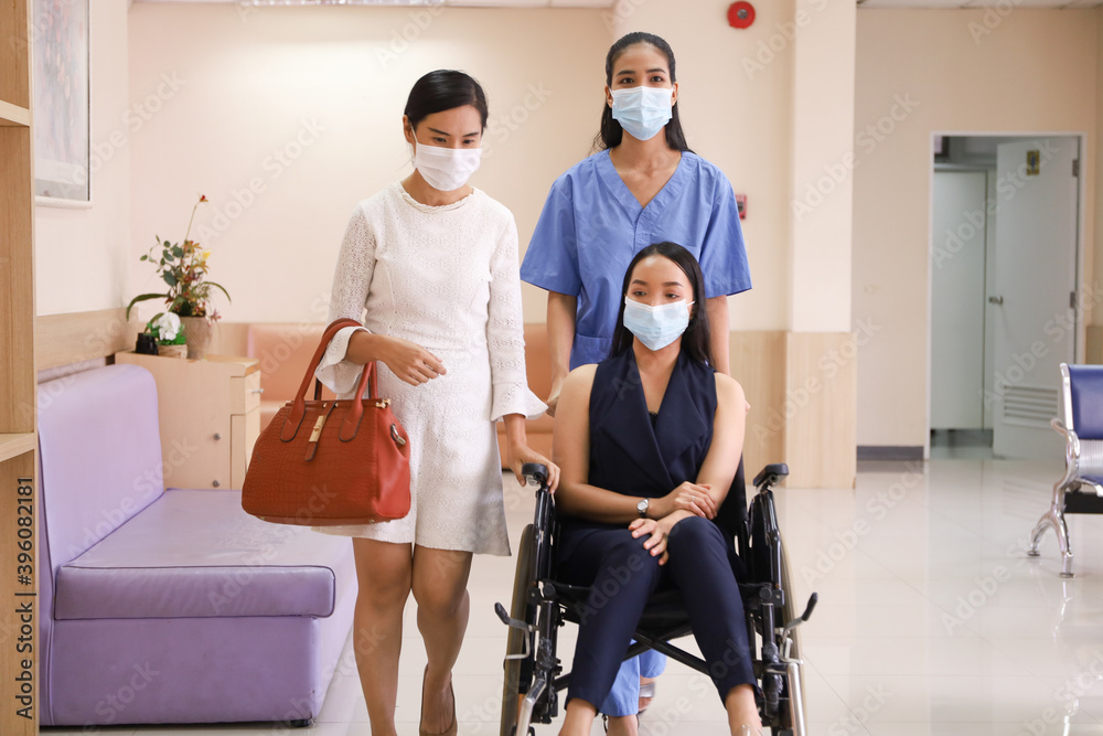Patient wear face mask and sick and sit on wheelchair meet and talking with doctor or nurse in hospital, healthcare treatment process and covid-19 pandemic outbreak concept