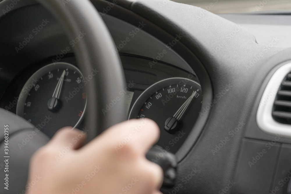 hand of a person driving a car