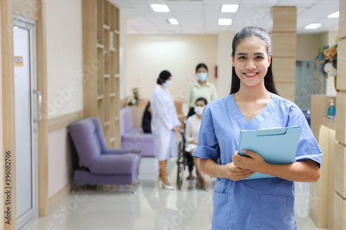 Portrait of nurse with patient wear face mask and sit on wheelchair meet and talking with doctor in hospital as background, healthcare treatment process and covid-19 pandemic concept