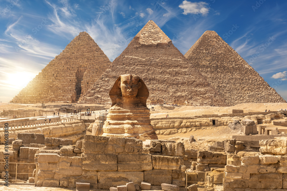 The Sphinx and The Great Pyramids of Giza near the ruins of a temple in Giza, Egypt