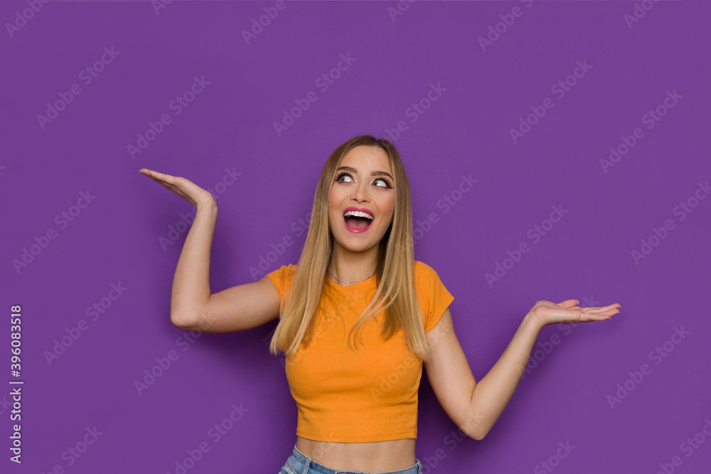 Excited Young Woman Is Holding Hands Raised, Looking Away And Shouting