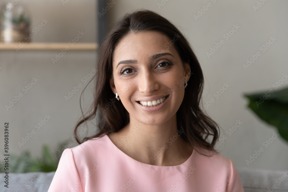 Head shot portrait social networks or dating application profile picture of attractive young happy indian arabic mixed race woman with toothy white teeth and perfect skin, looking at camera. Head shot portrait social networks or dating application profile picture of attractive young happy indian arabic mixed race woman with toothy white teeth and perfect skin, looking at camera.