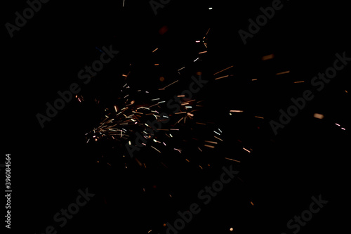 Glowing Flow of Sparks in the Dark. Fire sparks on a dark background