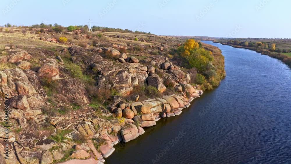 A stream flowing among huge stones covered with small dry plants in the warm evening light in picturesque Ukraine. Aerial UHD 4K drone realtime video, shot in 10bit HLG and colorized A stream flowing among huge stones covered with small dry plants in the warm evening light in picturesque Ukraine. Aerial UHD 4K drone realtime video, shot in 10bit HLG and colorized