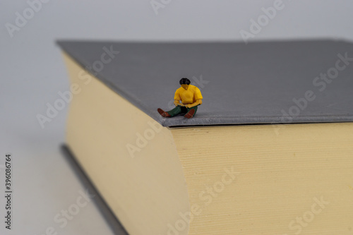 Small people reading on a book photo