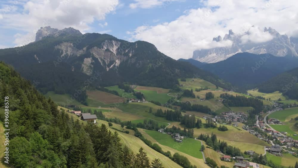 Side Pan Aerial of Quaint Town of St. Magdalena in the Alps, Dolomites, Italy Side Pan Aerial of Quaint Town of St. Magdalena in the Alps, Dolomites, Italy
