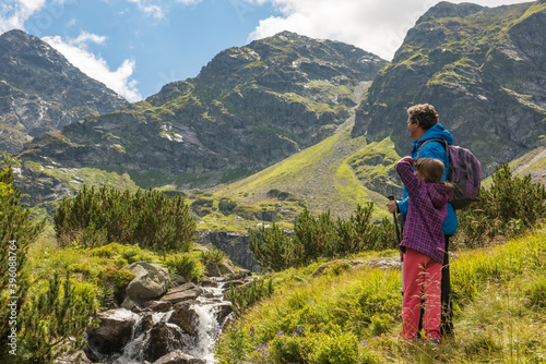 father and son travel hiking in mountains, family tourism, Tatra Mountains national park in Zakopane, Poland